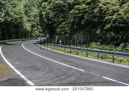 Country road in the forest concrete with speed limit signs of 50 km per hour sunny day