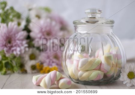 A jar with sweets. Marshmallow. 
A gentle still-life with sweets.