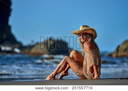young woman relaxing on the beach in summer day