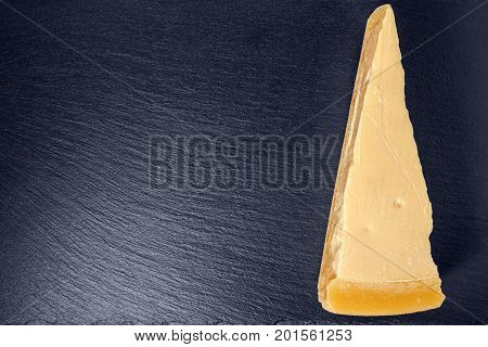 Top View Of Single Tasty Fresh Yellow Big Segment Piece Parm On Stone Slate Background, Close Up