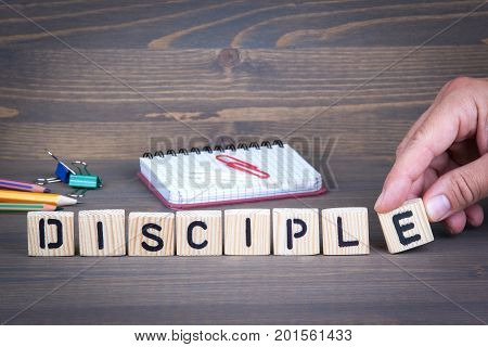 Disciple from wooden letters on dark texture background