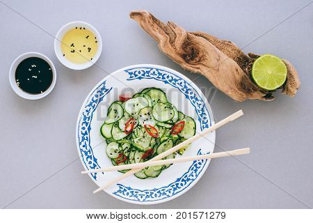 Asian salad and cucumber with sesame seeds dressed with rice vinegar lime and sesame oil