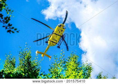 Modena 27 Aug 2017: an italian Elisoccorso ( helicopter rescue medical service ) yellow helicopter used for mountain rescue