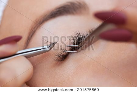 Eyelash Removal Procedure Close Up. Beautiful Woman With Long Lashes In A Beauty Salon. Eyelash Exte