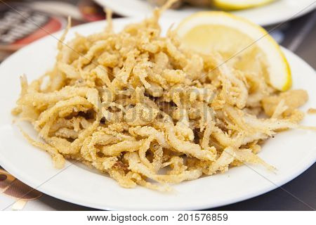 Plate of fried gobies or chanquetes with lemon Malaga Spain