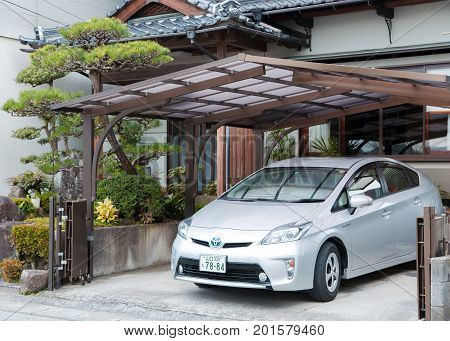 JAPAN, IWAKUNI, APRIL, 04, 2017 - Private Toyota Prius parked near the house under a small canopy in Iwakuni, Japan  