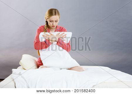 Sad Depressed Girl In Bed Gripping Pillow