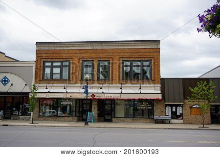 CADILLAC, MICHIGAN / UNITED STATES - MAY 31, 2017: 
The historic Kramer Building houses Blossom Boutique, Intermission Healthy Skin Care, Wexford/Crawford Hospital Organization, and the Music Station.