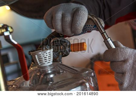 hands with gloves repair car, changing the fluid in cars in service