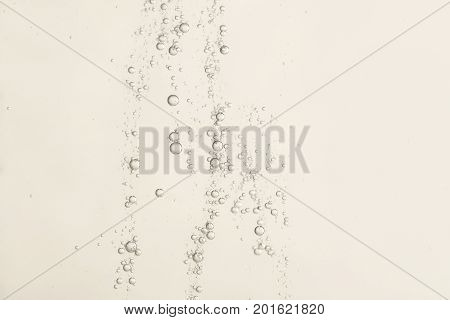 Beautiful golden fizz flows over a blurred background