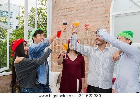 Young people holding glass talk in the party.