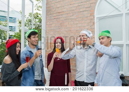 Young people holding glass talk in the party.