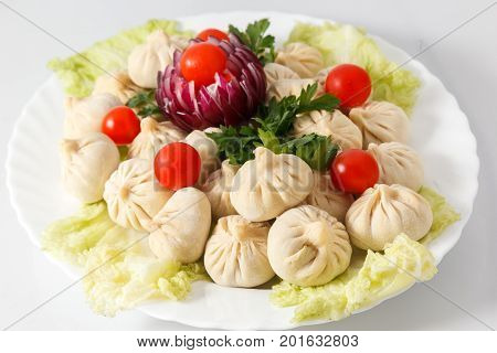 Frozen Dumplings On The White Plate With Green