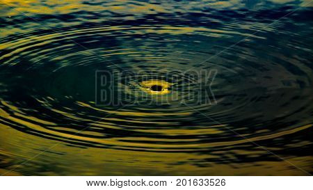 Abstract image of whirlpool hole of water at lake or pond like a blackhole in universe.