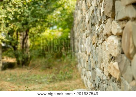 Old vintage stone wal with perspective view and blurred background. Selective focus
