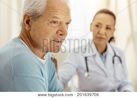 Pensive look. Portrait of a sad nice senior man feeling unhappy while thinking about his life
