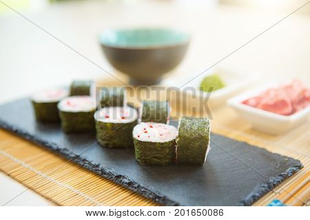 Sushi Rolls On Black Slate Surface. Japanese Food. Fried Sushi Roll