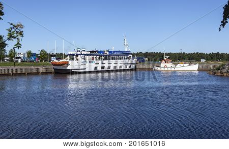 KOKKOLA, FINLAND ON JULY 07. View of Jenny moored by the port on July 07, 2017 in Kokkola, Finland. Channel, sidewalk and information office in the surrounding. Editorial use.