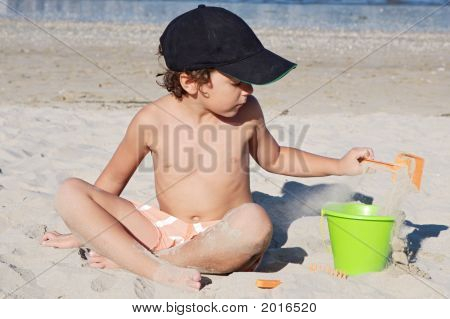 Boy Playing In The Beach