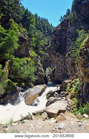 River and waterfall in forest, mountains of Caucasus, Russia.
