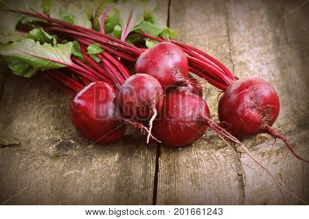 Fresh beetroot i on rustic wooden background. Harvest vegetable cooking conception . Diet or vegetarian food concept .