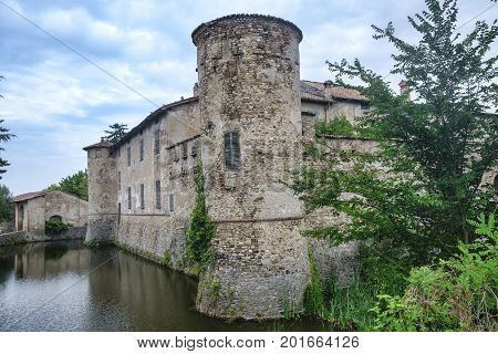 Lisignano (Piacenza Emilia Romagna Italy): the historic castle near Agazzano with waterlilies in the moat water