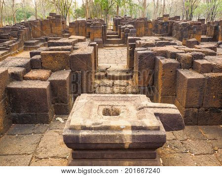 The stone yoni or female sex organ which is a basement of Shiva linga and stone columns inside the ancient Khmer-style temple in Mueang Singh historical park in Kanchanaburi Province Thailand.