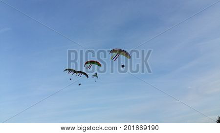 para-gliders in blue sky high freedom Lithuania