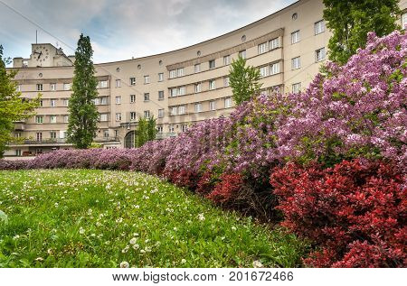 Municipal building in Floridsdorf Vienna with blooming bushes in the foreground