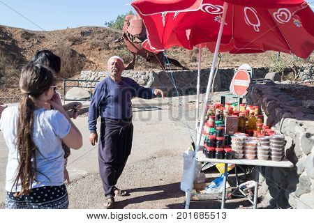 Golan Heights Israel August 27 2017 : The seller - druz trades with buyers up his store with canned sweets in the parking lot on Mount Bental. on the Golan Heights in Israel.