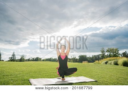 Woman Performing Toestand Yoga Pose