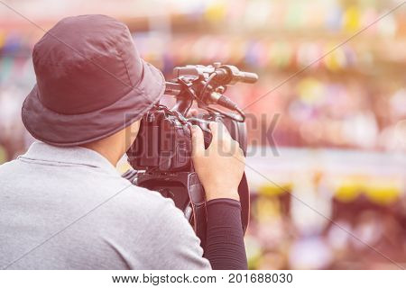 Cameraman Using Professional Digital Video Camera. Outdoor Setup And Working