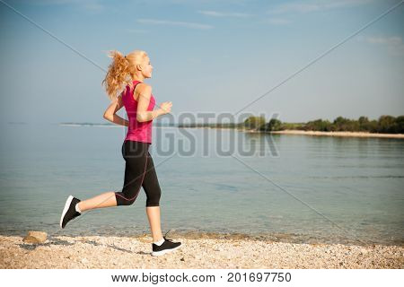 Jogging In Th Beach - Woman Runns Near Sea On Early Summer Morning