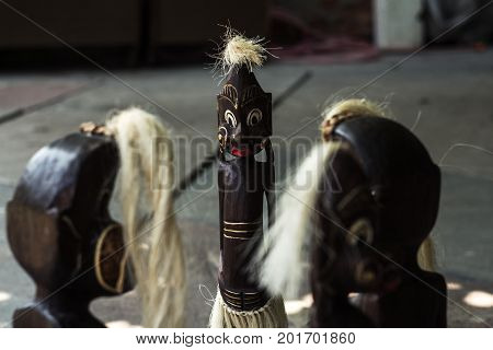 a wooden figures of people from tribes