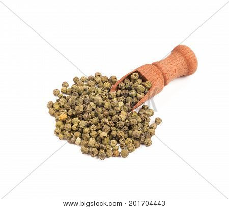 Wooden shovel with green pepper scattered from it.