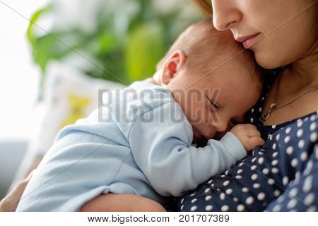 Young Mother, Holding Tenderly Her Newborn Baby Boy