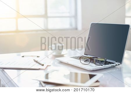 The tipical office desktop with pc, pens, notebook, laptop
