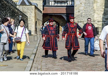 LONDON, GREAT BRITAIN - MAY 16, 2014: These are ceremonial guards (beefeaters) in everyday uniform among visitors to the Tower of London.