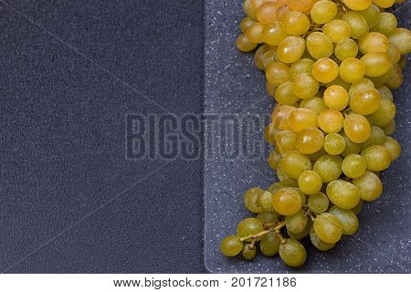 fresh delicious and healthy organic concord grapes on cutting board. copy-space