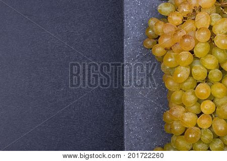 fresh delicious and healthy organic concord grapes on cutting board. copy-space