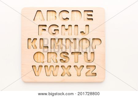 Wooden board with English alphabet letters. Sorter toy for child development and education.