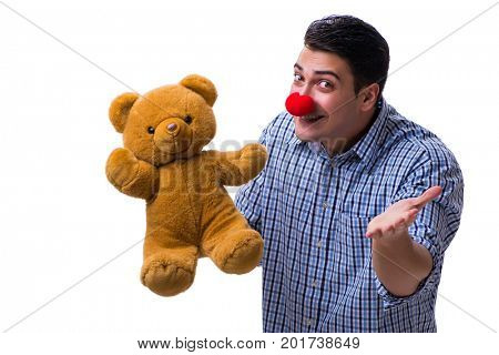 Funny clown man with a soft teddy bear toy isolated on white bac