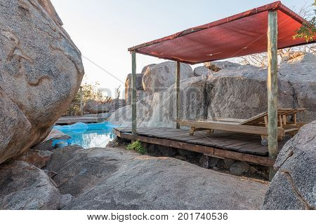 HOADA NAMIBIA - JUNE 27 2017: A swimming pool hidden between boulder on a hill at the Hoada Camp in the Kunene Region of Namibia