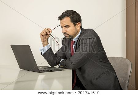 Arab Man Woking In His Laptop In The Kitchen