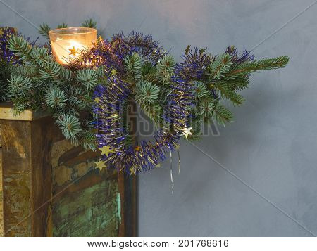Christmas Decoration Candle In Glass And Decorated Silver On Spruce Tree Branch On Old Painted Dress