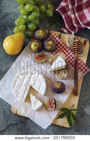 Goat cheese figs fruits and bread. Top view