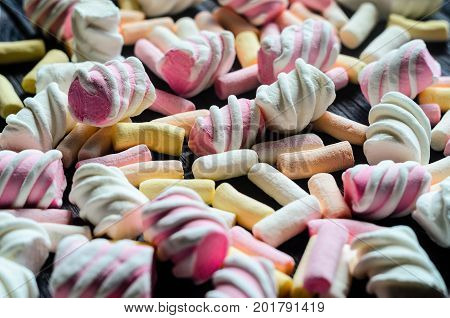 Multicolored Marshmallow Background. Background of multi-colored and different in shape and size of marshmallows. Sweets background