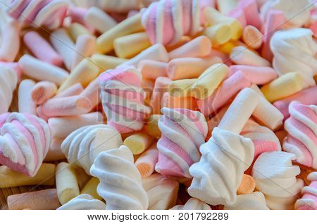 Multicolored Marshmallow Background. Background of multi-colored and different in shape and size of marshmallows. Sweets background