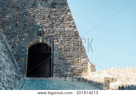 Main entrance to the Stari Grad of Ulcinj Montenegro. The gate of fortress in the Old town in a sunny summer day.