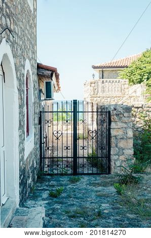 Old narrow street in Stari Grad of Ulcinj Montenegro. The fortress in the Old town in a sunny summer day.